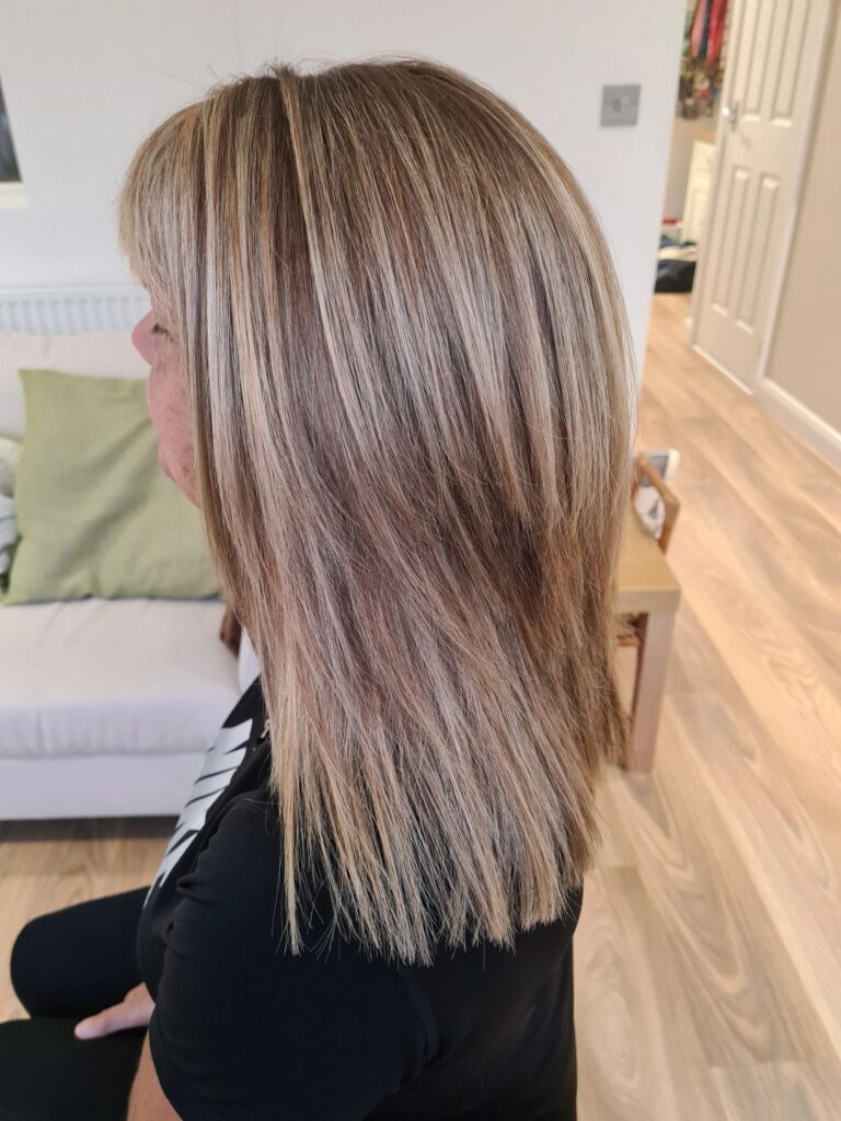 Woman with long hair done Blonde hair coloring